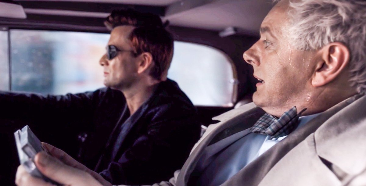 Crowley and Aziraphale driving together in the Bentley.