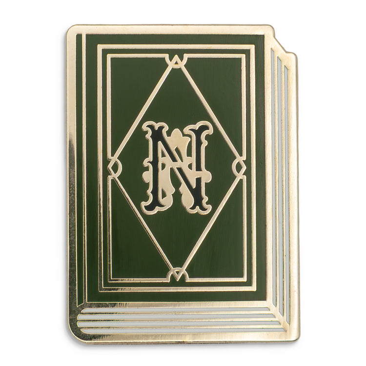 Photograph of a Good Omens enamel pin:  Agnes Nutter's book of prophecies.