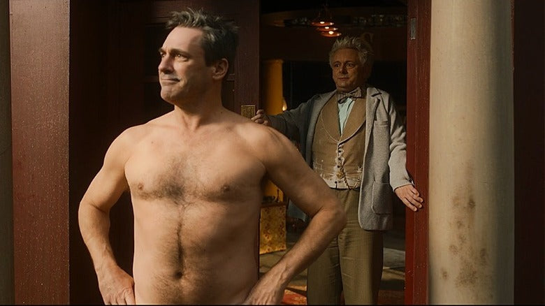 Gabriel standing, naked, on the doorstep of A.Z. Fell & Co bookshop as Aziraphale looks taken aback.