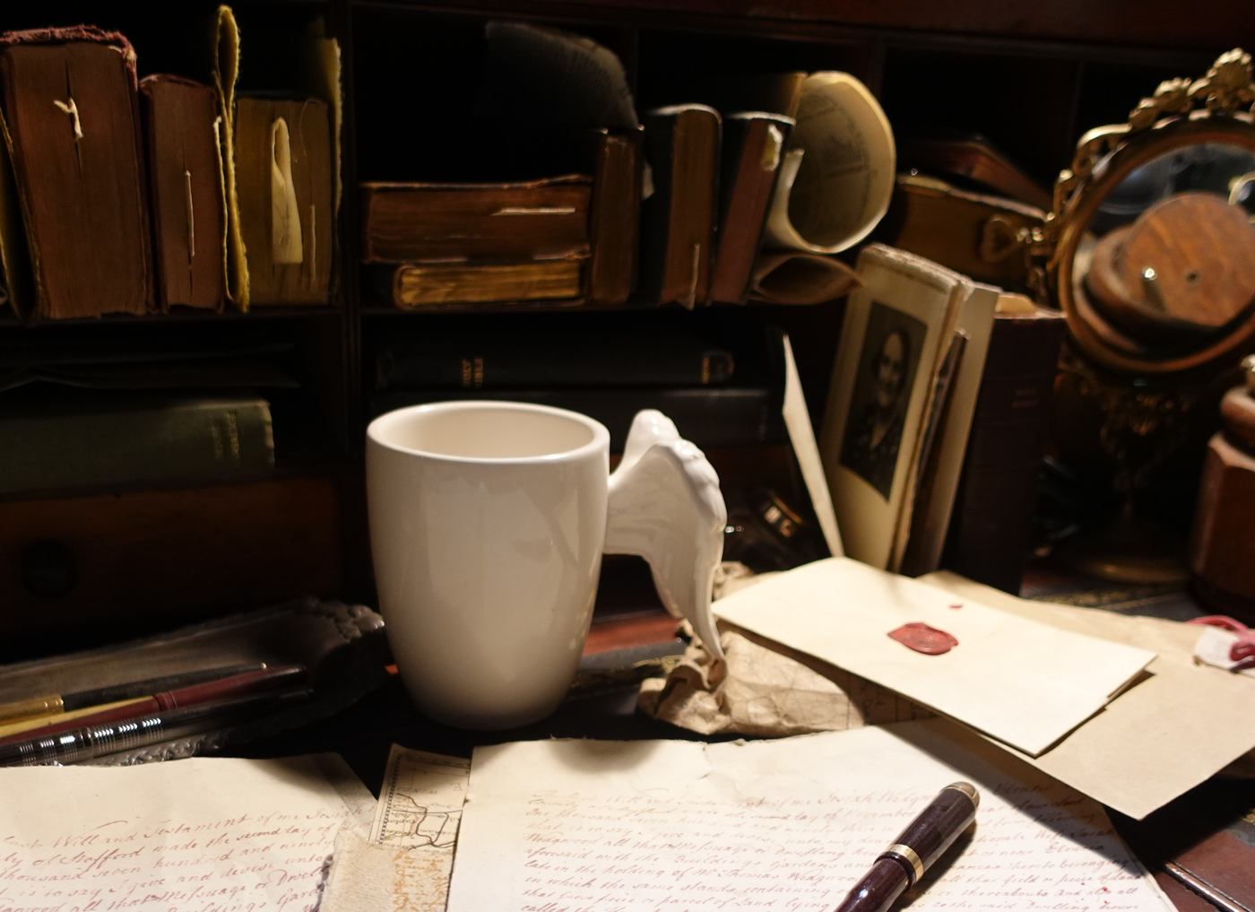 Photograph of Jim's mug sitting on Aziraphale's desk.