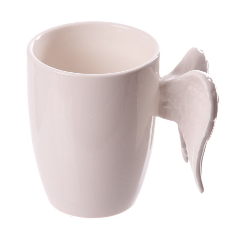 A white coffee mug featuring angel wings.