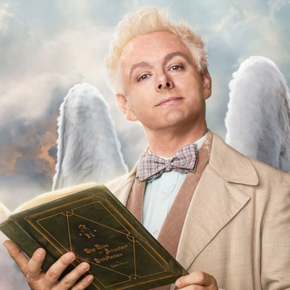 Aziraphale holding Agnes Nutter's book of prophecies.