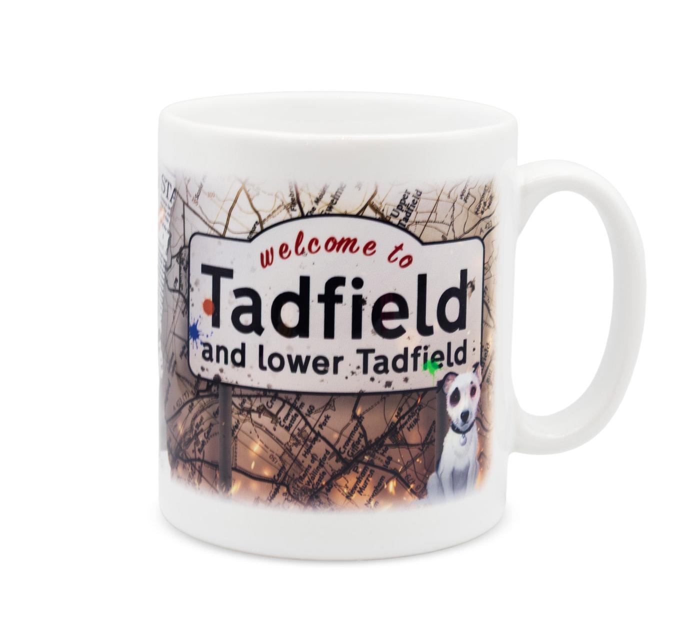 A white mug featuring an illustrated sign that says 'welcome to Tadfield and lower Tadfield'.